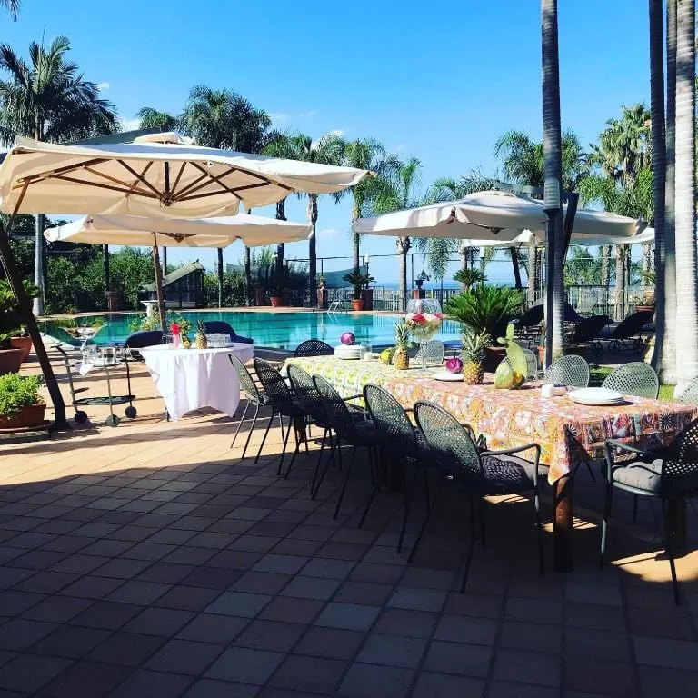 Tavolo apparecchiato in terrazza a bordo piscina